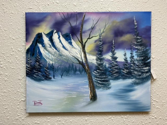 A winter landscape with mountains in the background 