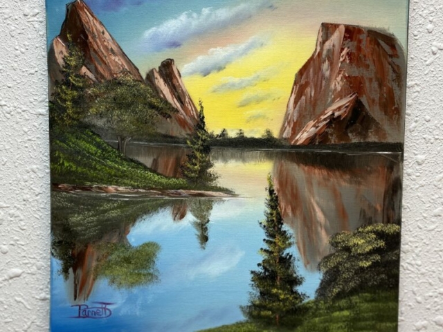 A painting with mountains in the background and beautifully still water in the foreground